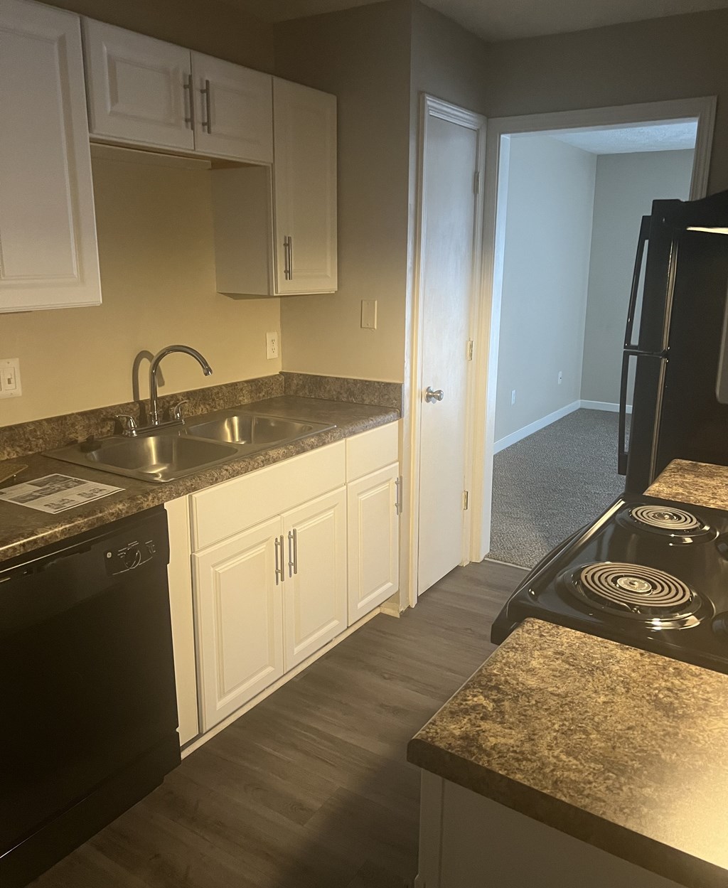 a kitchen with white cabinets and granite counter tops